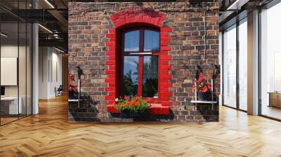 Red window with red flowers of old brick tenement house. Ruda Slaska, Poland. Wall mural