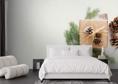 Christmas background with an eco-friendly packaged gift in craft paper and fir branches on white. Christmas Presents wrapped in gift paper. Zero waste Christmas holiday concept. Flat lay, copy space Wall mural