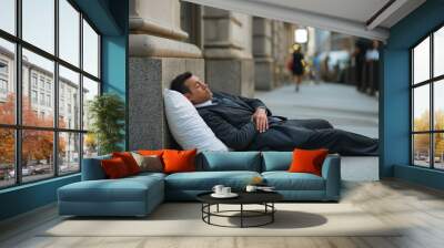 Corporate finance businessman exhausted and stressed sleeping on a sidewalk in the city Wall mural