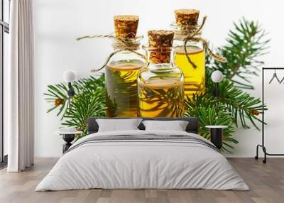 3 small glass bottles of cypress oil with a white background, and green pine leaves around the bottles Wall mural