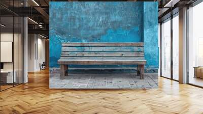 Weathered wooden bench on blue wall background, AI generated image. Wall mural