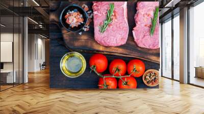 Banner Raw meat beef steak organic fresh ingredient on wooden board table background in kitchen with rosemary, salt, garlic, tomato, olive oil. Meat beef on wooden plate for beefsteak with copy space Wall mural