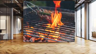 BBQ Barbecue grilled meat stick on fire flame with hot charcoal cooking outside. Beef grilling picnic outdoor with smoke bacon spicy sausage for party. Grill pork bbq on fire flame Wall mural