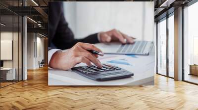 Close up business man hands using calculator counting tax financial bill. Man hands calculating number, data, graph, chart audit planning accountancy on business report. Tax audit Finacial concept. Wall mural