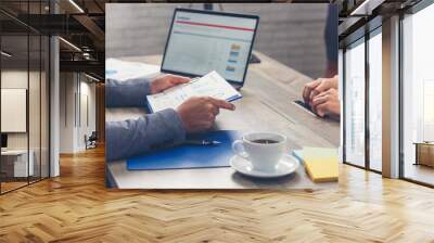 Happiness two businessman working together confident team meeting in office desk. Team business man partners working with laptop startup company. Asian man colleague friendship at work staff meeting Wall mural