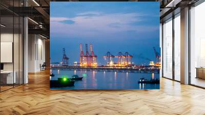 Logistic shipping quay boat in twilight sky night Engineering crane depot at logistic export terminal control. Warehouse freight background container yard loading quayside harbor port Logistics. Wall mural