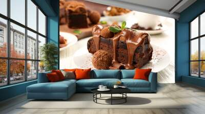 a piece of chocolate cake with mint on the table, close-up Wall mural