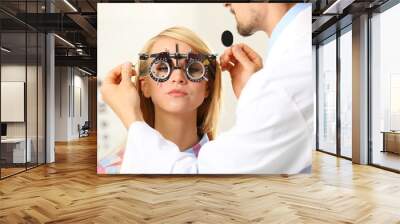 Adult male doctor examing adult female patient Wall mural