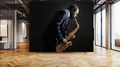 African American jazz musician playing the saxophone on grey background Wall mural