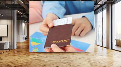 Agent giving passport and ticket to customer in the office of travel company Wall mural