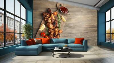 baked chicken wings with tomatoes and rosemary on cutting board Wall mural