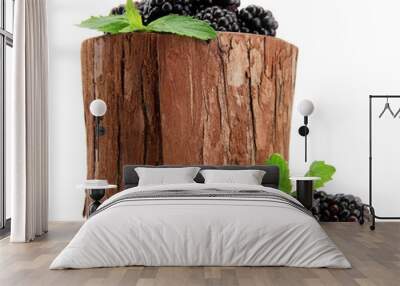 beautiful blackberries with leaves in wooden vase isolated Wall mural