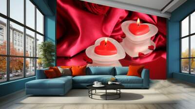 beautiful candles and rose on red silk background Wall mural