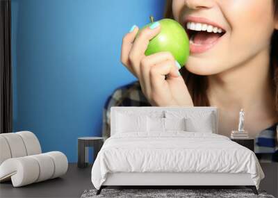 Beautiful girl eating apple, closeup Wall mural