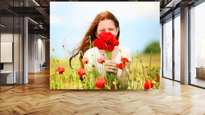 Beautiful girl in poppy field Wall mural