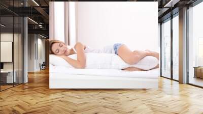 Beautiful girl sleeping with body pillow in bedroom Wall mural