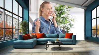 Beautiful woman talking on phone indoors Wall mural