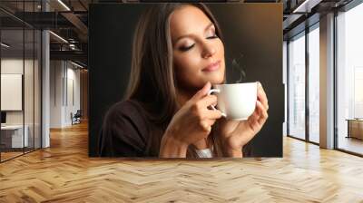 beautiful young woman with cup of coffee on brown background Wall mural