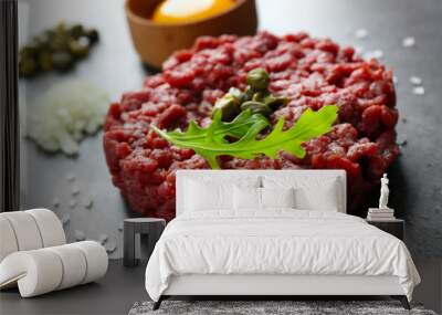 Beef tartare served with an egg yolk on a grey surface, close up Wall mural