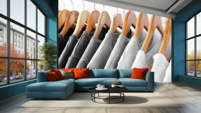 black, grey and white t-shirts on hangers, close up view Wall mural