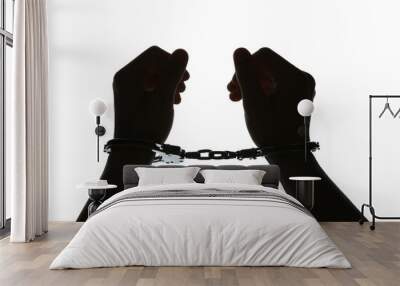 black silhouette of man hands in handcuffs on light background Wall mural