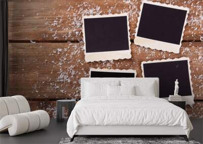 Blank photo frames and snowflakes on wooden table background Wall mural