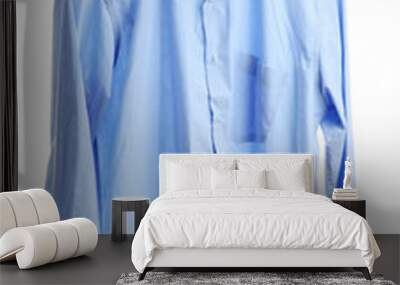 blue shirt on wooden hanger isolated on white Wall mural