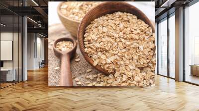 Bowl and plate with raw oatmeal on table Wall mural