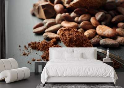 Bowl with aromatic cocoa beans and chocolate on grey background, close up Wall mural