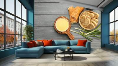 Bowl with beer cheese dip and bread on wooden background Wall mural