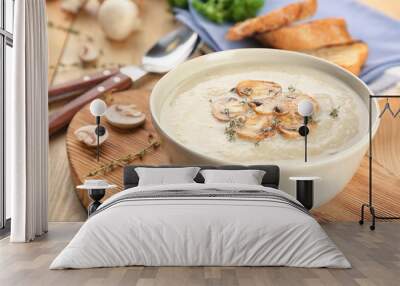 Bowl with delicious mushroom soup on wooden table Wall mural