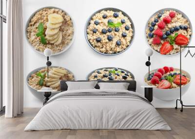 Bowls of oatmeal with berries and fruits on white background Wall mural