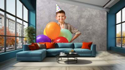 Boy with color balloons on grey background Wall mural