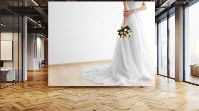 Bride in beautiful dress holding wedding bouquet Wall mural