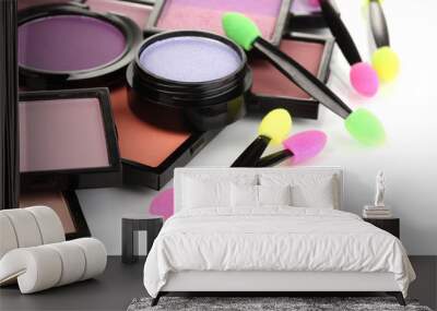 Bright eye shadows and sponge brushes for foundation isolated Wall mural