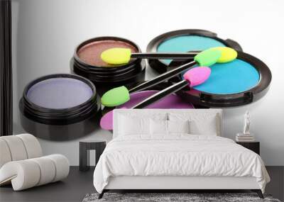 Bright eye shadows and sponge brushes for foundation isolated Wall mural