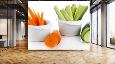 Bright fresh carrot and cucumber cut up slices in bowl isolated Wall mural