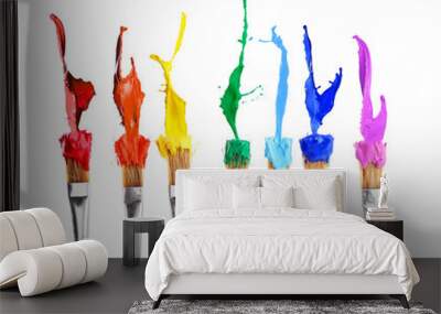 Brushes with colorful paints, isolated on white Wall mural