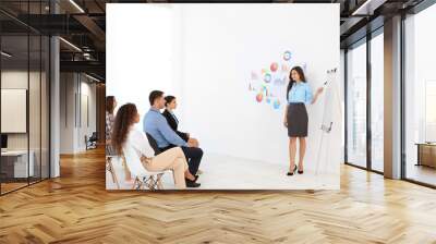 business trainer giving presentation to group of people Wall mural