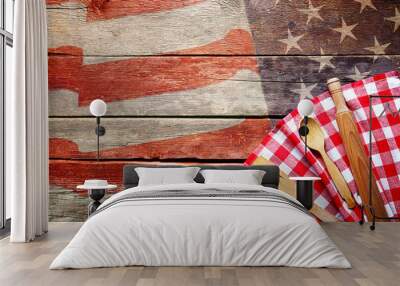 Checkered napkin and cutlery on wooden background. American cuisine food concept Wall mural