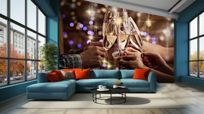 clinking glasses of champagne in hands on bright lights background with snow effect Wall mural