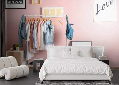 collection of clothes hanging on rack in dressing room Wall mural