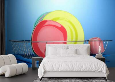 Color plates in rack on blue background Wall mural