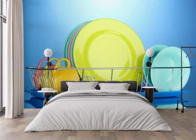 Color plates in rack on blue background Wall mural