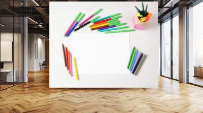 Colored pencils and blank paper sheet on wooden table Wall mural