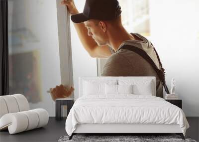 Construction worker installing window in house Wall mural