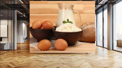 Cottage cheese in clay bowl with jug of milk, loaf of bread Wall mural