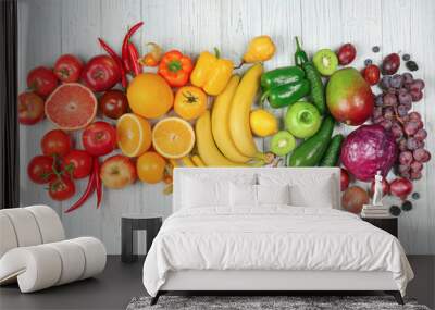 Creative composition made of fruits and vegetables in rainbow colors on wooden background, flat lay Wall mural