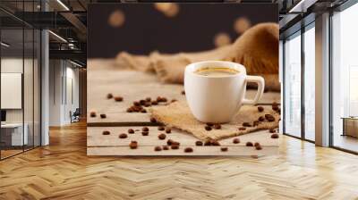 Cup of coffee on table on brown background Wall mural