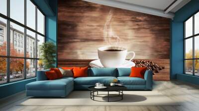 Cup of coffee with grains on wooden background Wall mural